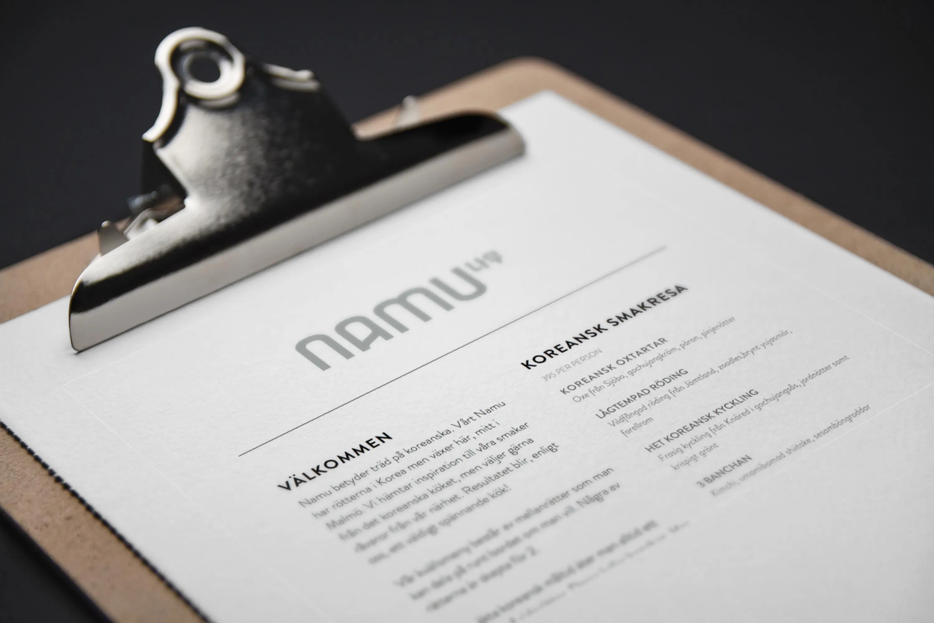Namus meny på clipboard — detalj i typografi och form
